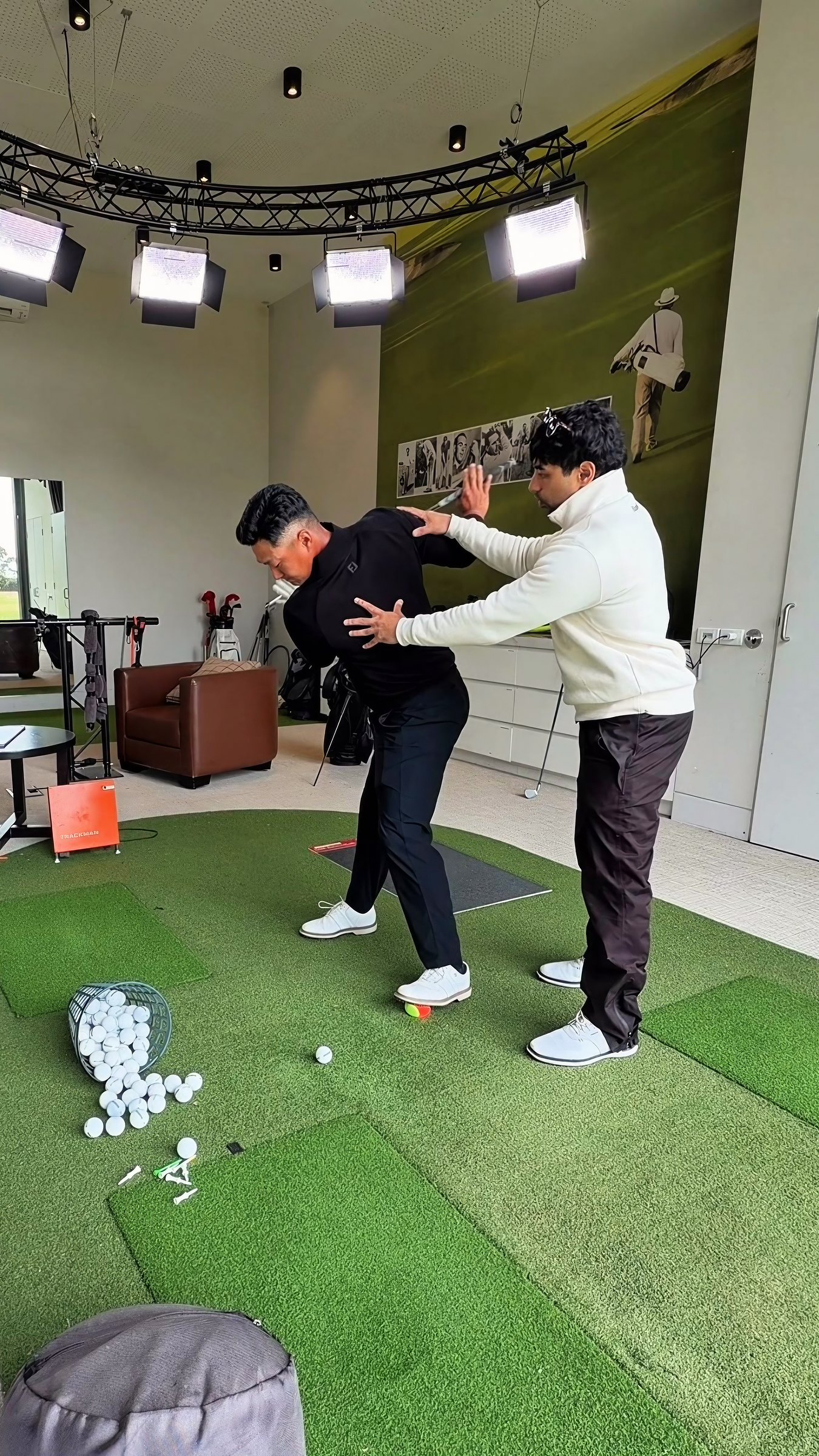 Brandon Rave coaching a player hands on in the studio