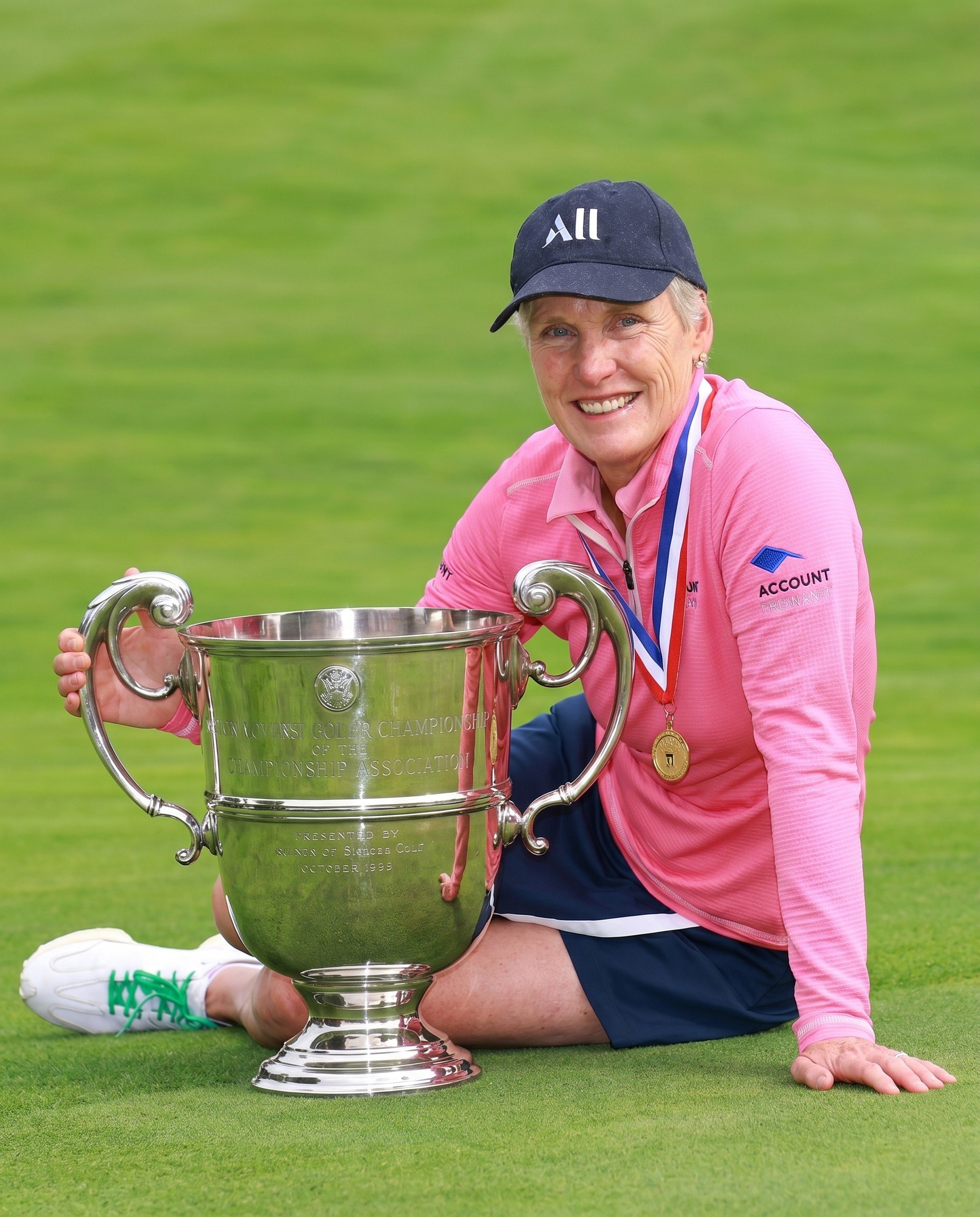 A player with a silver cup on the green